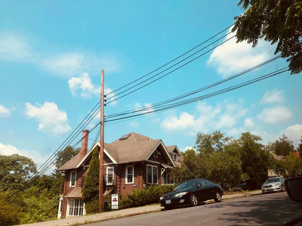 Street view of a Brampton home with “For Rent” sign and parked cars, ideal visual for sell home fast Brampton services
